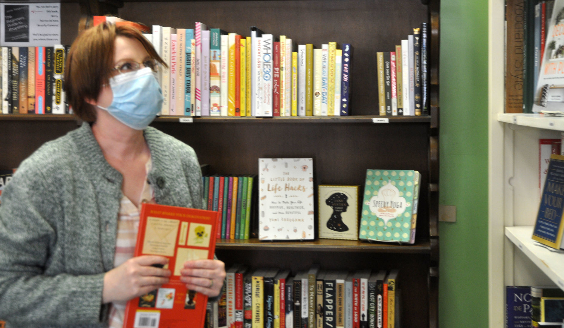 Raina Remeeus, owner of Dust Bunny Books, 152 Center St., organizes some of her books